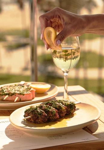 a person is pouring a glass of wine at Hotel Erwin Venice Beach in Los Angeles
