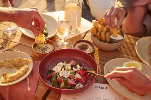 a table with a bowl of food and french fries at Hotel Erwin Venice Beach in Los Angeles