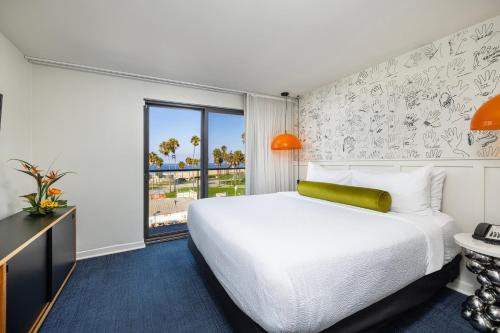 a hotel room with a large bed and a window at Hotel Erwin Venice Beach in Los Angeles