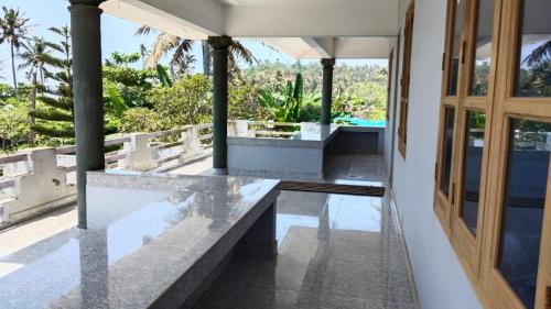 an external view of a house with a door and a pool at Marhba home stay in Varkala