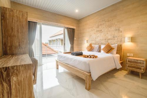 En eller flere senge i et værelse på Nari Homestay Canggu