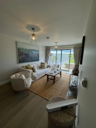 a living room with a couch and a table at No 1 The Hides Luxury House in North Norfolk in Titchwell
