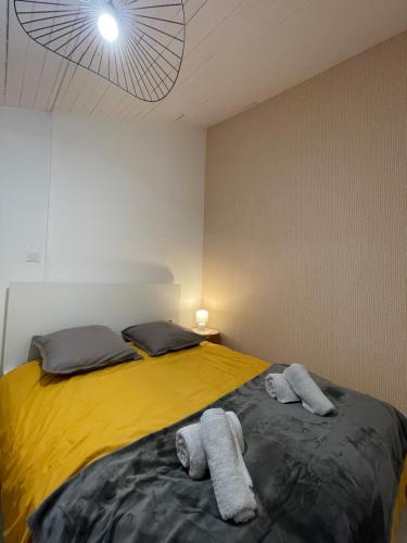 a bedroom with a bed with towels on it at T1 Duplex Cosy - Madeleine - Netflix in Bergerac