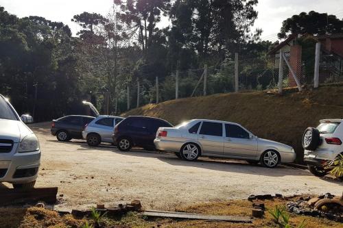 a row of cars parked in a parking lot at Pousada Chales da Mantiqueira - Campos do Jordão in Campos do Jordão