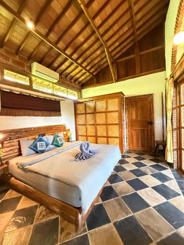 a bedroom with a bed and a checkered floor at Villa Helios in Pai