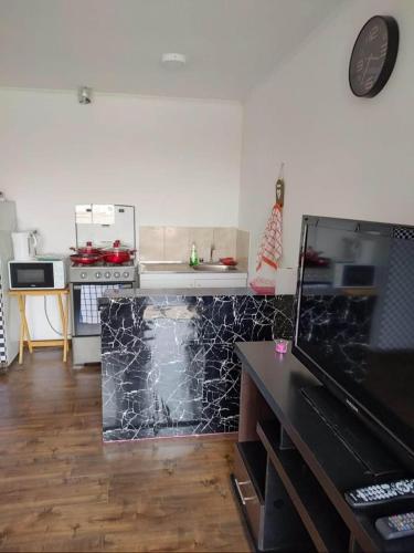 a kitchen with a stove and a counter top at Mini departamento centrico in Arica