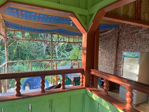 a porch of a house with a large window at Casas Salomão in Santo António