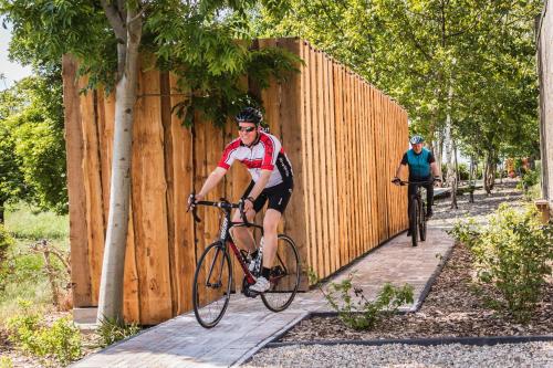 a man riding a bike next to a fence at Time-Out Zussen in Riemst
