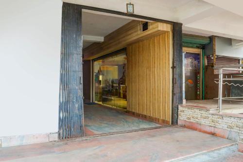 an entrance to a building with a wooden door at Hotel O The Triotel Inn in Dhanbād