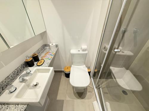 a bathroom with a toilet and a sink and a shower at On Jurupis in Sao Paulo