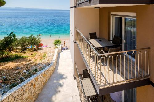 a balcony of a building with a view of the beach at Villa Veronika in Omiš