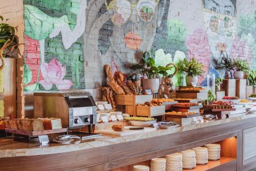 a bakery with bread and pastries on a counter at VELA OCEAN LUXURY SUITES Nha Trang Centre in Nha Trang