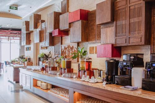 a kitchen with a long counter in a restaurant at VELA OCEAN LUXURY SUITES Nha Trang Centre in Nha Trang