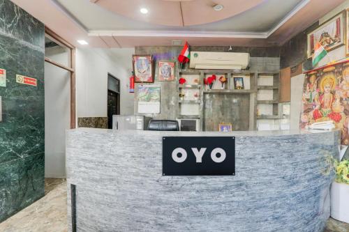 a counter in a restaurant with a sign on it at Hotel O Shivam International in Utrāhtia