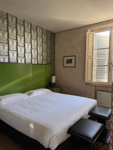 Una cama o camas en una habitación de Hotel Verdi Boutique Hotel