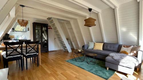 a living room with a couch and a table at Baumberger Waldhäuschen in Billerbeck