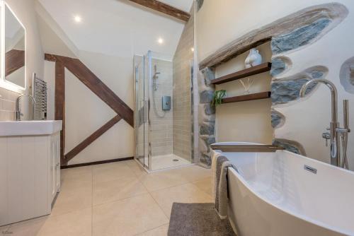 a bathroom with a shower and a sink at Hendre-Feinws in Pwllheli
