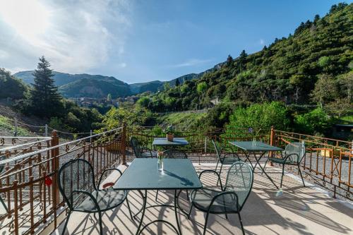 a table and chairs on a balcony with a view at Aeriko Guest House in Stemnitsa
