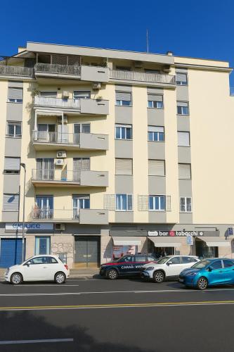 a large building with cars parked in front of it at Casa Chanel in Rome