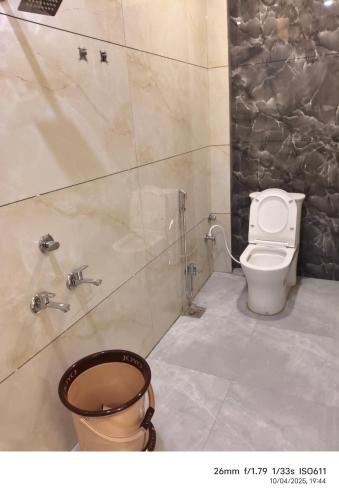 a bathroom with a toilet and a shower at Hotel Gokul in Ujjain