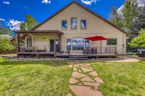 a house with a patio and a red umbrella at 156 Teal Circle in Pagosa Springs