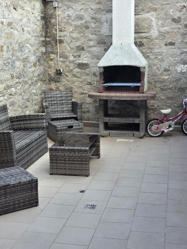 a patio with a pizza oven and chairs and a bike at Harmonie-Oase in Alsleben