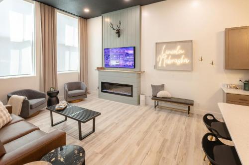 a living room with a couch and a fireplace at Boutique 1BR Condo - Walk to Memorial Stadium - Historic Hayward Place in Lincoln