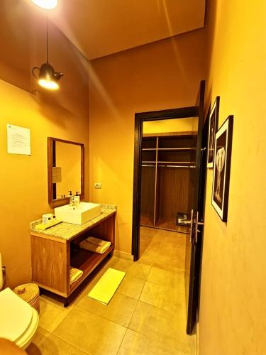 a bathroom with a sink and a mirror at The BIRD in Marrakech