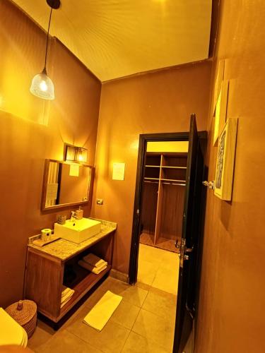 a bathroom with a sink and a mirror at The BIRD in Marrakech