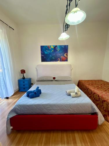 a bedroom with a bed with two stuffed animals on it at Holiday House Ginevra in Formia