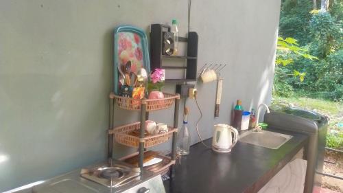 a kitchen counter with a sink and two shelves at White Angel in Mirissa