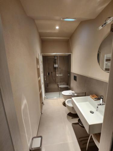 a bathroom with two toilets and a shower at CA' 'D Ricardo in Alba