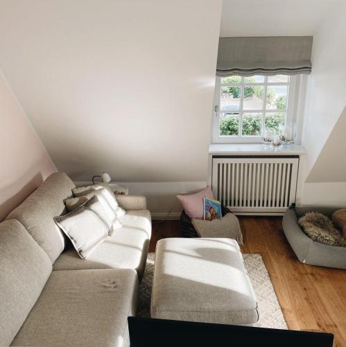 a living room with a couch and a window at Ocean-View-II-Holiday-Apartments-Sylt in Rantum