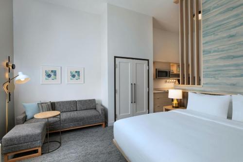 a hotel room with a bed and a couch at TownePlace Suites North Little Rock  in North Little Rock