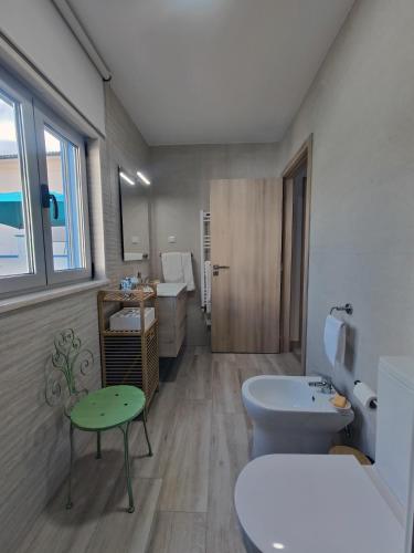a bathroom with a white toilet and a sink at Casa da Avó Julia in Carvide
