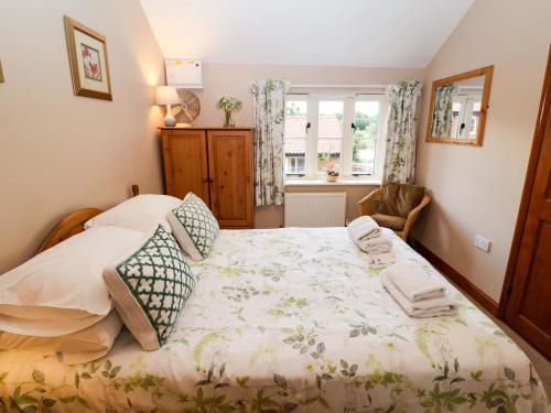 une chambre avec un grand lit et une fenêtre dans l'établissement Hayloft, à Henley