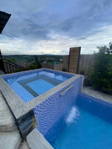 a swimming pool with blue water in a backyard at Dicimulacion Staycation House in Angono