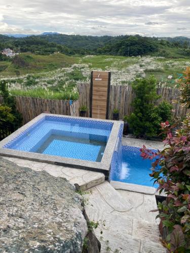 a swimming pool sitting on top of a rock at Dicimulacion Staycation House in Angono