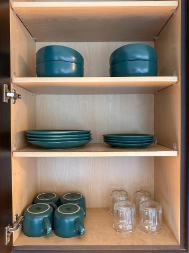 a wooden cabinet with blue bowls and glasses in it at Monthier Downtown SP2S6U08 in Los Angeles