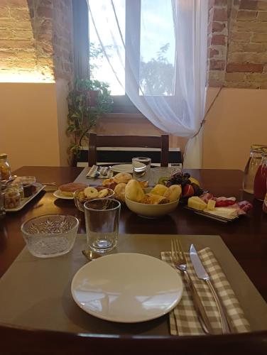 a table with plates and bowls of food on it at Il Borgo B&B in Castellinaldo