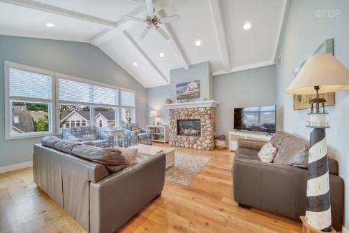 a living room with two couches and a fireplace at Luxury Home with Harbor Views Hot Tub Walk to North Beach Dog Friendly in South Haven