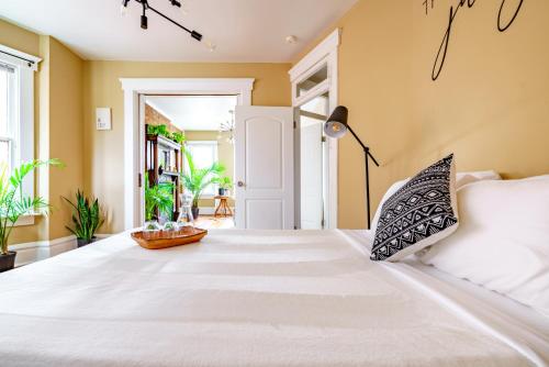 a bedroom with a large bed with white sheets at Prime Location Top Rated Free Parking Clean in Columbus