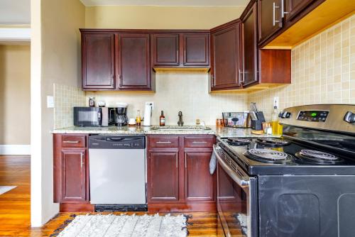 a kitchen with wooden cabinets and a stove top oven at Prime Location Top Rated Free Parking Clean in Columbus