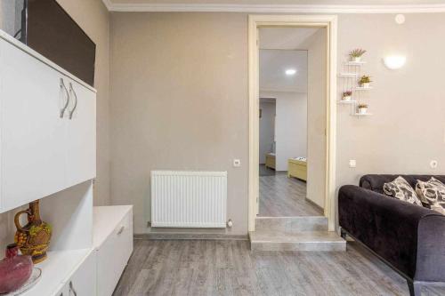 a living room with a couch and a hallway at Apartment Old Tbilisi in Tbilisi City