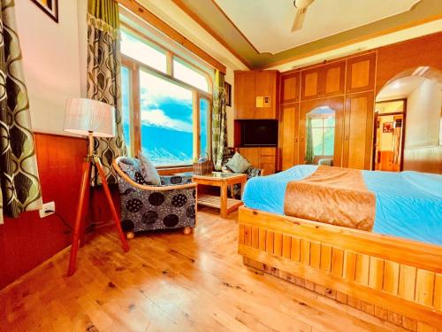 a bedroom with a bed and a window at Shree Ram Cottage, Manali - 1,2,3 Bedroom Luxury Cottages Available in Manāli