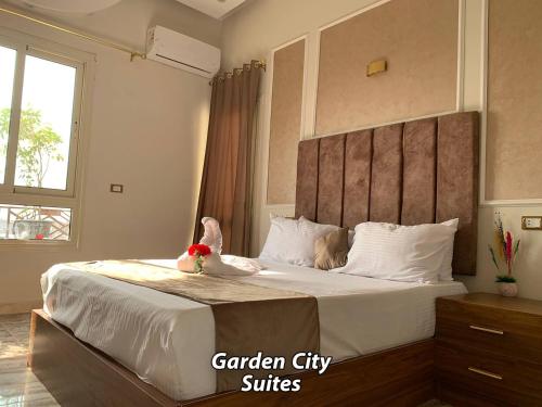 a bedroom with a bed with two stuffed animals on it at Garden City Suites Downtown in Cairo