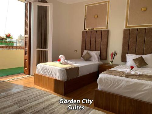 a hotel room with two beds and a balcony at Garden City Suites Downtown in Cairo