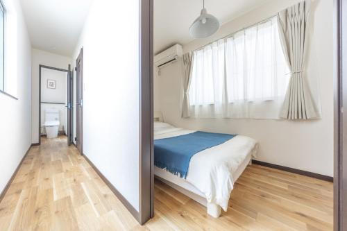 a bedroom with a bed and a mirror at Nogata Station 3 minutes on foot , 15 minutes to Shinjuku in Tokyo