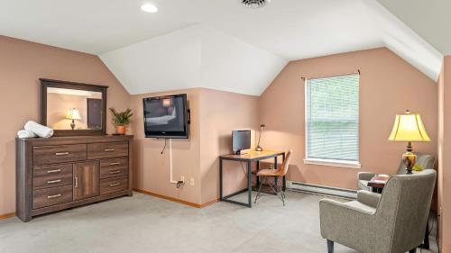 a living room with a tv and a chair and a dresser at Lakeview Retreat w Kayaks Game Room Firepits Gated Community w Lake Beach Access in East Stroudsburg