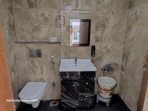 a bathroom with a sink and a toilet at Hello Studio in Noida